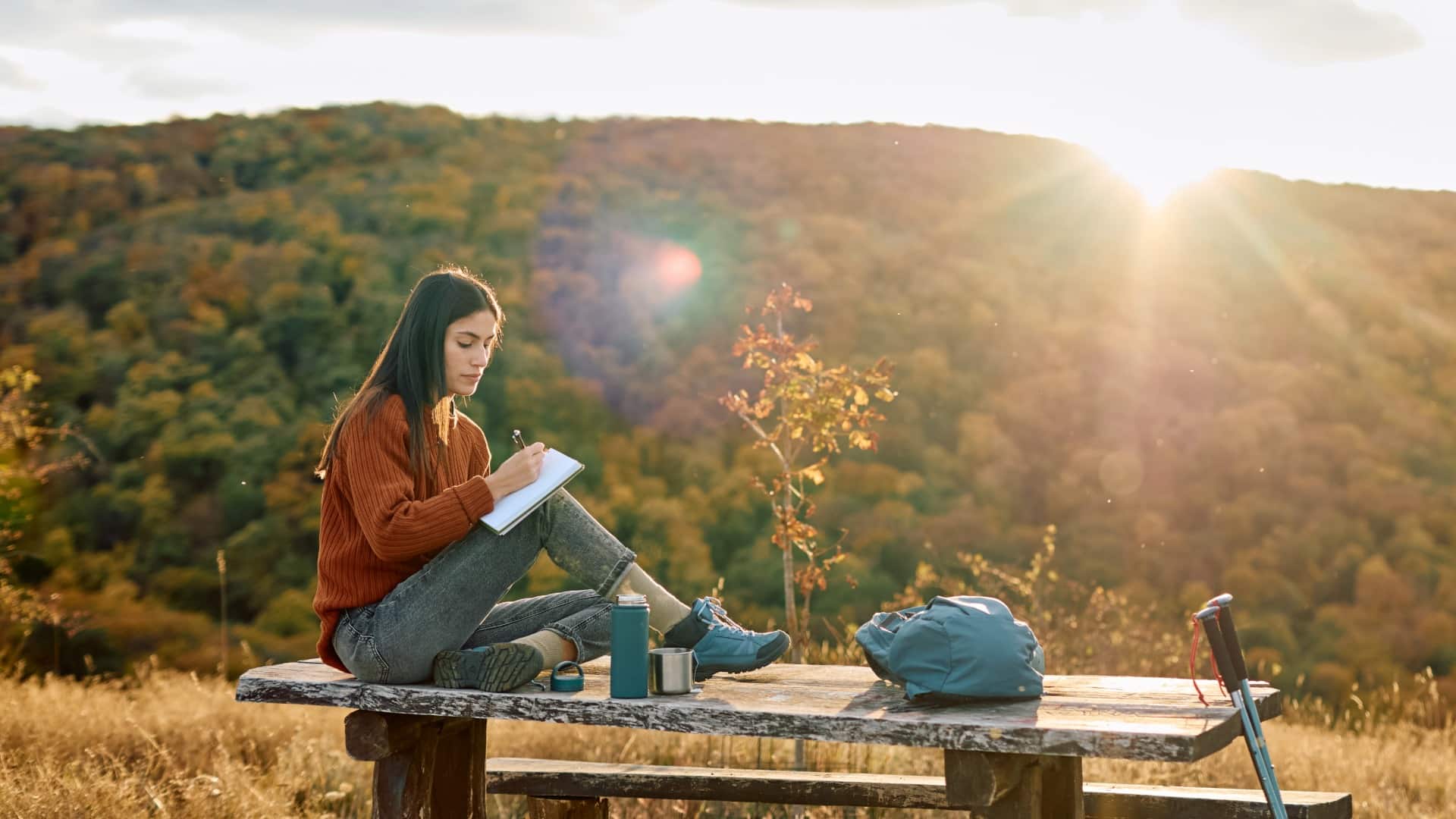 Woman writing in her journal on a death anniversary to ease anxiety