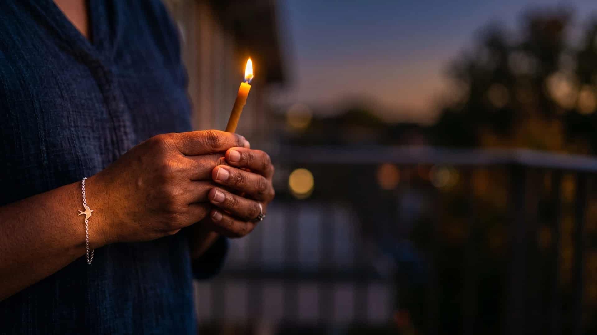 woman holding a candle for bereavement overload in grief professionals